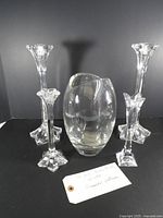 Front view of vase centered between four candlesticks