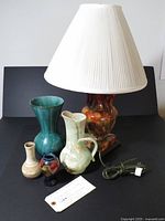 Group shot of all five items: lamp with shade, Moorcroft vase, BMP vase, Cleland vase, aqua pitcher
