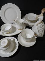 Overall view of Val D'Or dinnerware pieces with figurine