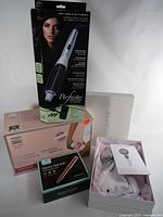 Four boxed devices: Perfecter Fusion Styler, Silk’n Flash&Go, Electric Nail Drill, white EMS massager box