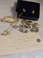 Entire lot laid out showing bracelet, necklace, brooch, earrings