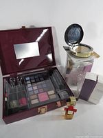 Lot overview showing makeup palette, compact, boxed fragrance, Julep box and mini perfumes