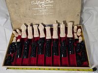 Open box showing all sculptured pieces in trays and lid graphics