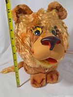Front view showing full plush with measuring tape indicating height