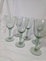Set of six green glass goblets grouped