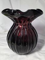 Full view of vase showing color, ribbed body and ruffle rim