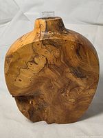 Front view of wooden bud vase with glass insert visible