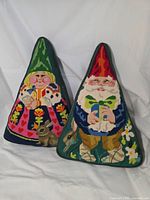 Front view of both triangular gnome pillows
