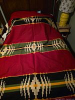 Blanket spread on full bed showing overall pattern and colors