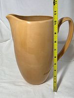 Side view of pitcher with tape measure showing height ~11 in
