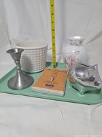 Group shot showing all five items with tape measure for scale