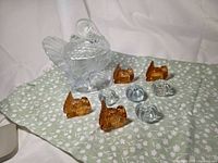 Lot overview showing clear lidded turkey bowl, four amber turkey candle holders, three clear pumpkin candle holders