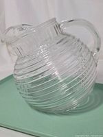 Side view of ribbed clear glass pitcher showing overall shape