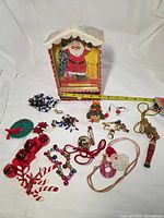 Group shot of Santa music box with tape measure and all jewelry pieces spread out