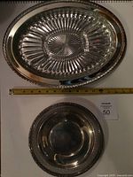 Round sterling tray and oval glass dish in metal base, overall view