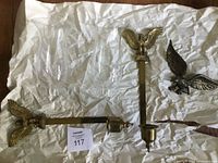 Overall lot showing two brass sconces, two hurricane shades, separate brass eagle