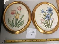 All three framed cross-stitch pieces side by side with ruler for scale