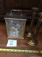 Clock and two candlesticks with tape measure
