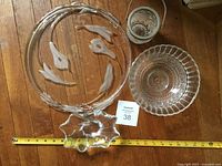 Overview of all four glass pieces with measuring tape for scale