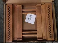 Trivet in open box showing wooden construction and inlay pattern