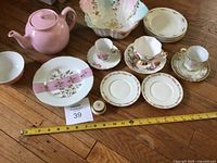 Entire grouping of teapot, bowls, plates, teacups, lidded pot with measuring tape for scale