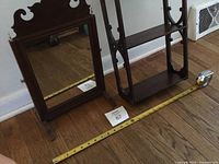 Mirror and shelf side by side with measuring tape