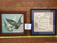 Both framed prints side by side with measuring tape for scale