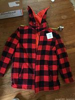 Front view of reversible plaid wool jacket with hood displayed