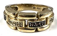 Full view of gold ring showing segmented design and diamond settings