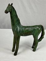 Full view of bronze horse sculpture standing on all four legs