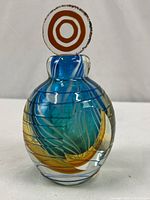 Full view of art glass piece with disc on top