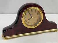 Front view of Howard Miller Westminster chime clock showing dial and case