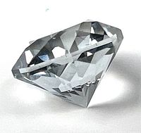 Side view of faceted transparent gemstone