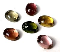 Six multicolour oval tourmalines displayed