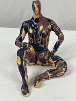 Full view of seated ceramic figure