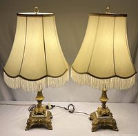 Full view of both matching brass lamps with shades