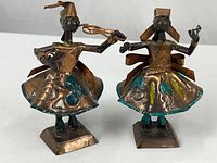 Front view of both copper dancer sculptures