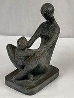 Full view of seated mother and child sculpture on base
