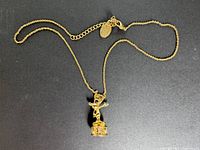 Full view of gold-tone necklace and pendant