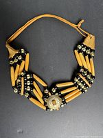 Full view showing entire necklace layout, strands, medallion, suede tie