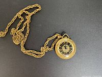Full view of pendant watch attached to chain