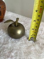 Apple bell next to tape measure showing height
