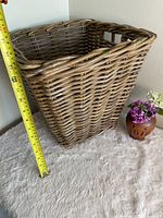 Full view showing height measurement with tape, square wicker basket