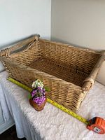 Full view of rectangular wicker basket with measuring tape showing length and width