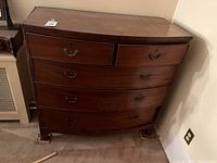 Front view of mahogany bow front dresser with five drawers