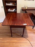 Top view of mahogany drop-leaf table showing grain and overall surface