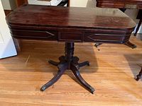 Full view of closed mahogany folding games table