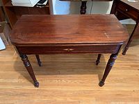 Top view of table folded showing mahogany surface and size