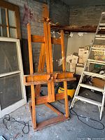 Full view of hardwood studio easel opened in garage
