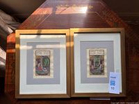 Both framed miniature paintings on table showing size and frames